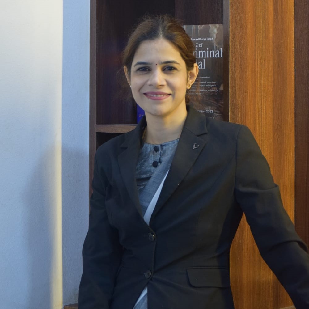 Advocate Archana Chikorde standing in her law office in Wakad Pune wearing a blazer, providing professional legal consultation and advisory services